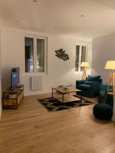 a living room with a couch and a coffee table at Appartement à Fécamp avec vue port et mer Le Sémaphore in Fécamp +13 photos