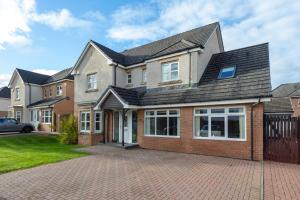 a large house with a brick driveway at 45 Doonvale Drive in Ayr