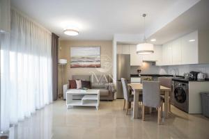 Una cocina y una sala con una mesa y un comedor. en Casa Bibi Ivan Luxury Homes 4ªPlta Sur 1ªLinea, en Oropesa del Mar