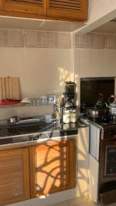 a kitchen with a stove and a counter top at Amaan ⴰⵎⴰⴰⵏ Cottage in Agadir