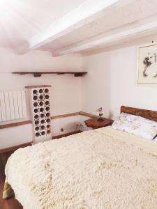 a white bedroom with a bed and a table at Villa La Pineta in Umbertide +43 photos