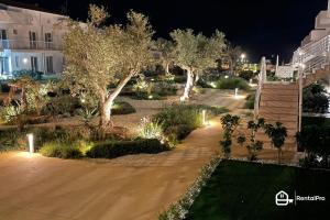 a garden at night with trees and lights at [Suite Marzamemi] – Near Sea in Marzamemi