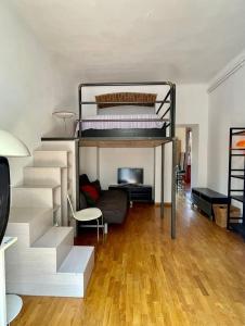 a room with two bunk beds and a couch at Apartment Navigli Milano in Milan