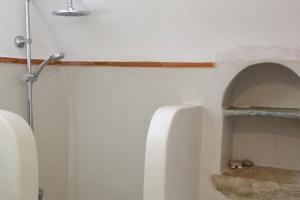 a bathroom with two urinals on a wall at Axion Studios in Aroniadika