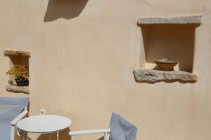a room with two windows and a white table and chairs at Axion Studios in Aroniadika
