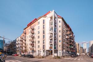 a tall apartment building on a city street at Miedziana 14 by Homeprime in Warsaw