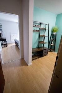 a room with a mirror and a room with a bed at Industrial Charm Loft in Düren - Eifel