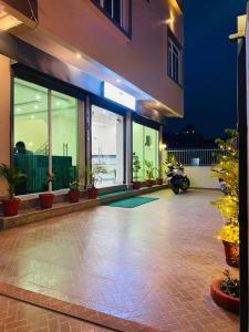 ein Gebäude mit einer Terrasse mit Pflanzen und einem Motorrad in der Unterkunft Hotel Mangalam in Siddharthanagar