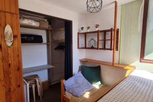 a bedroom with a bed and a chair in it at Appartement Lélex vue sur les pistes in Lélex