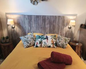 a bedroom with a bed with a wooden headboard at Au coeur d'un cocon.... in Pennautier