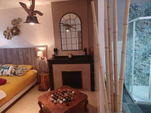 a living room with a couch and a fireplace at Au coeur d'un cocon.... in Pennautier +9 photos
