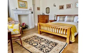 a bedroom with a bed and a couch and a chair at Wethele Manor in Leamington Spa