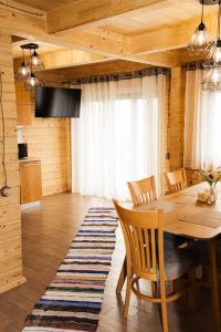 a dining room with a wooden table and chairs at Готель Logindariy 