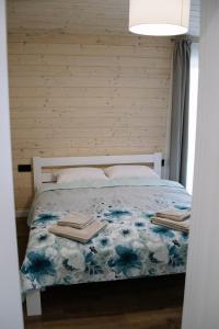 a bedroom with a bed with a blue floral bedspread at Готель Logindariy 