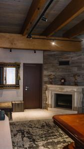a living room with a fireplace and a door at Готель Logindariy in Rokosovo