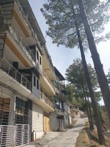 a building with balconies on the side of it at Beverly Hills Kuza Gali, Nathiagali District Abbottabad in Abbottabad