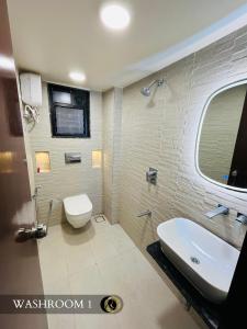 a bathroom with a white toilet and a sink at 3BHK - Entire property - New listing at OFFER PRICE in Aurangabad