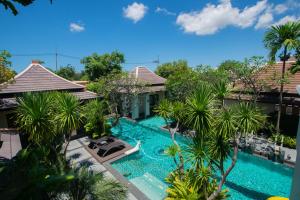an aerial view of a resort swimming pool with palm trees at Luxury Thai Style Swimming Pool Villa, Private housekeeper,6 Bedrooms in Nong Prue