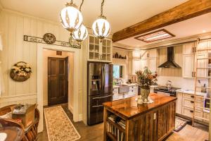 a kitchen with a wooden island in the middle at Luxury waterfront fairytale themed home - Carmen Elisabeth in Burlington