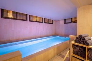 a large swimming pool in a room at SOWELL HOTELS Le Parc & Spa in Briançon