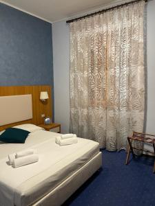 a hotel room with a bed and a window at Hotel Relais VillaGrancassa in San Donato Val di Comino