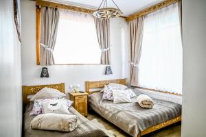 a bedroom with two beds and a window at Domek u Zosi in Zakopane