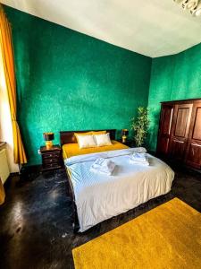 um quarto com 2 camas numa parede verde em cozy & charming apt. downtown em Timisoara