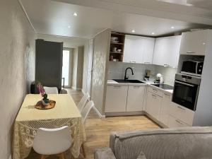 a kitchen with a table and a dining room at Appartement centre ville. in Bastia