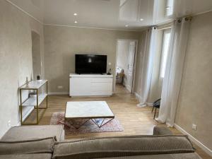 a living room with a couch and a flat screen tv at Appartement centre ville. in Bastia