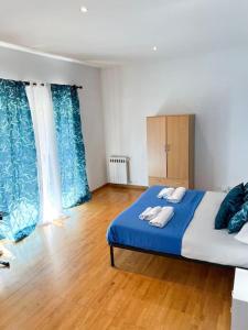 a bedroom with a bed with two towels on it at Virgy Green House in Rome