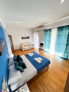 a bedroom with a large blue bed in a room at Virgy Green House in Rome