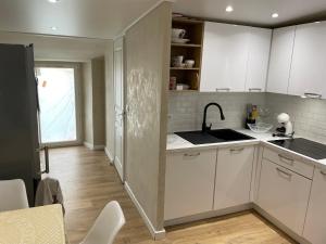 a kitchen with white cabinets and a sink at Appartement centre ville. in Bastia +8 photos