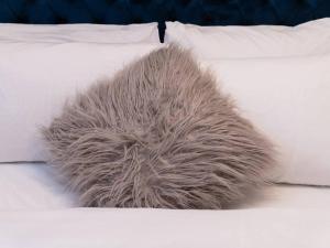 a ball of faux fur on a bed at Pass the Keys Cosy 2 Bed Flat in London in a Historic Building in London