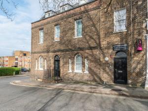 a brick building with a black door on a street at Pass the Keys Cosy 2 Bed Flat in London in a Historic Building in London