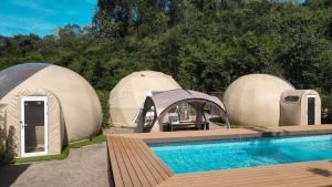 a group of three dome tents with a swimming pool at The X10 Glamping Pool Villa Khaoyai เขาใหญ่ - SHA Certified in Pak Chong