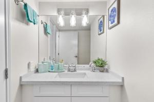 a bathroom with a sink and a mirror at 3BR Beach Condo: Private Balcony & Pool Access - South Padre Island, Texas in South Padre Island +35 photos