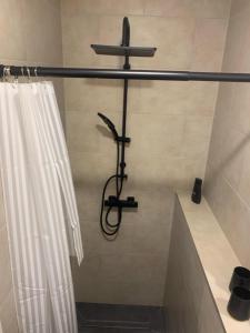 a shower in a bathroom with a shower curtain at Apartment in zentraler Lage in Willich in Willich