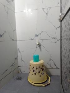 a cake sitting on a floor in a bathroom at HOTEL AMAAN PALACE in Mumbai