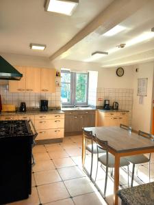a kitchen with a table and a table and chairs at Château du Bourg in Saint-Denis-de-Gastines +40 photos