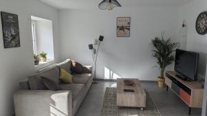 a living room with a couch and a coffee table at Gîte des Basses Rivières in Huismes