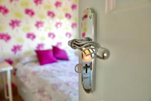 a door with a latch to a bedroom with a bed at Anna's House in Ickleford
