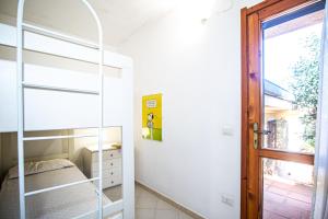 Ένα ή περισσότερα κρεβάτια σε δωμάτιο στο 3 Le Perle Di Stintino - Happy Rentals