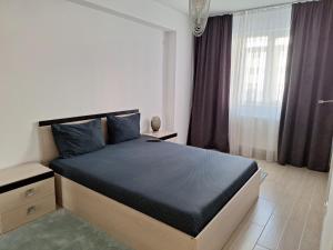 - une chambre avec un grand lit dans l'établissement Cazare Apartament 2 camere, à Chiajna