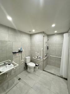 a bathroom with a toilet and a sink and a shower at Comma Boutique Hotel in Taipei