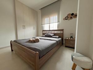a bedroom with a bed with two donuts on it at Albert's Apartment Center 202B in Larnaca
