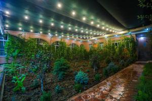 a building with a garden with plants and lights at Сабзавот Давр Дача in Yalanghoch