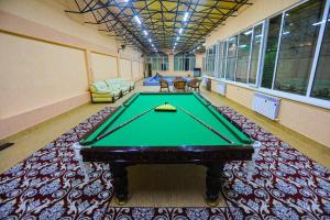 a billiard room with a green table in it at Сабзавот Давр Дача in Yalanghoch