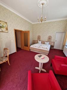 a living room with a bed and a table at Pension Villa Anna in Bad Schandau