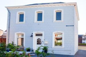 a white brick house with white windows at Stijlvolle @ luxe vrijstaande woning Maastricht in Eijsden