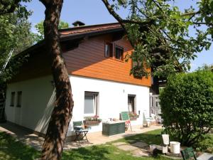 a house with an orange roof and a yard at Holiday home in Wernberg with pool and sauna in Wernberg